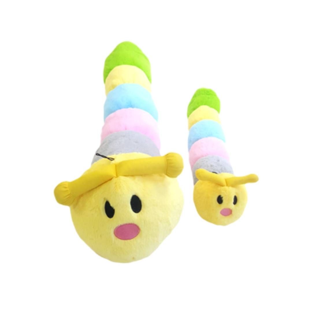 Plush toy caterpillar with a smiling face on a white background